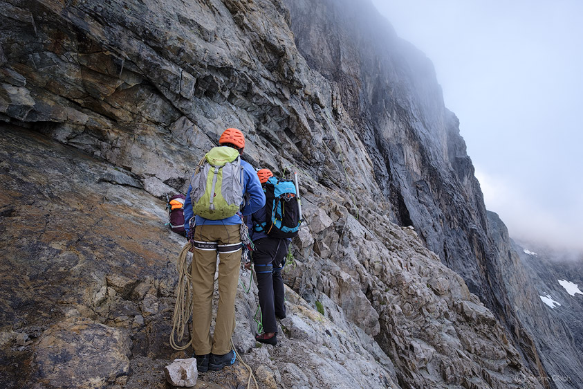 Alpinistes attendant leur tour pour grimper au pied du mur Castelnau. Parc National des Ecrins.